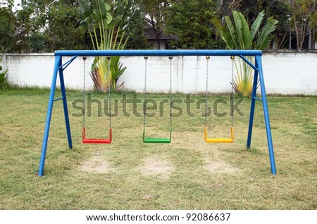 Swing set on the playground Royalty-Free Stock Photo #92086637