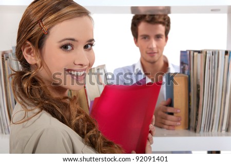 Couple flirting in a library