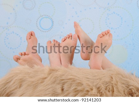 close-up of children's feet over furry blanket