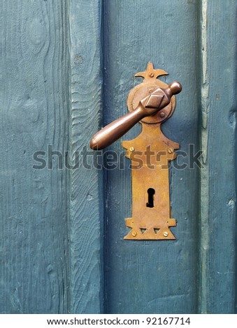 an old wood door with metal handle closeup