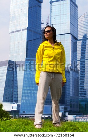 young brunette girl in a tracksuit in the background of a big city