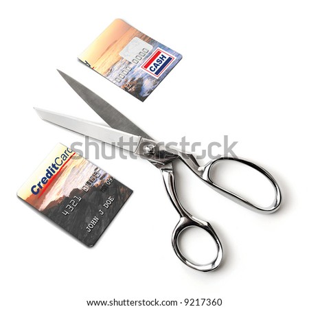 A pair of scissors cutting a credit card in half on a white background Beach scene photo and globe used are owned by me, James Steidl aka jgroup.