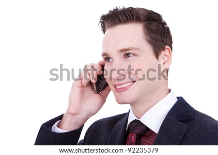 Portrait of a handsome young business man speaking over cellphone against white, lookig away from the camera
