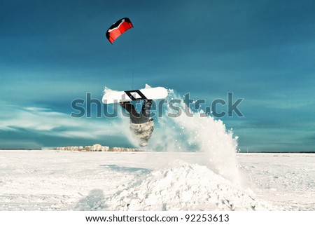 kiting on a snowboard on a frozen lake Royalty-Free Stock Photo #92253613
