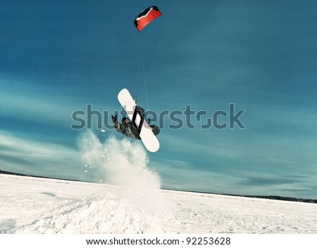 kiting on a snowboard on a frozen lake Royalty-Free Stock Photo #92253628