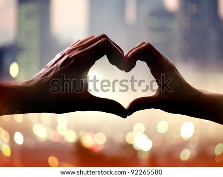 Silhouette of hands in form of heart when sweethearts have touched Royalty-Free Stock Photo #92265580