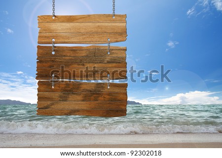wood sign hanging on beach Royalty-Free Stock Photo #92302018