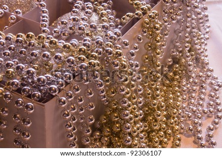 Christmas ornaments in a box, which much shining pearl covers,