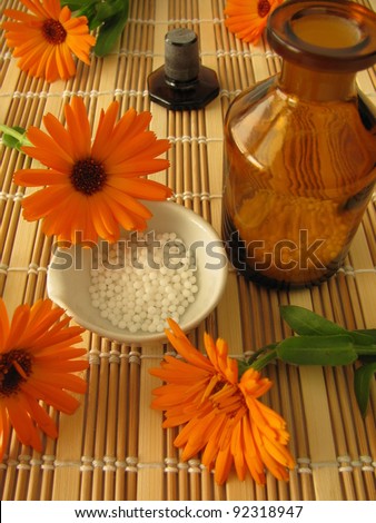 Marigold flowers and homeopathic pills