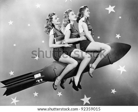 Three women sitting on a rocket Royalty-Free Stock Photo #92359015