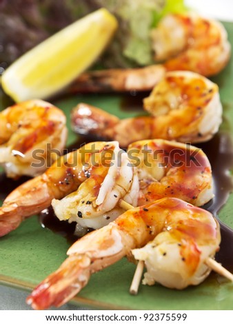 shrimp skewer  with lettuce and lemon slice Royalty-Free Stock Photo #92375599
