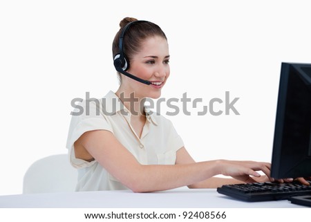 Smiling secretary making an appointment against a white background