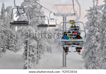 Ski chair lift  with skiers. Ski resort in Ruka, Finland Royalty-Free Stock Photo #92453656