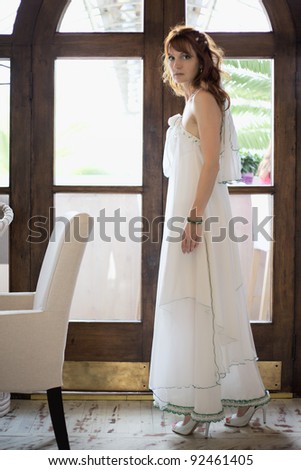 beautiful woman in white wedding dress at interior