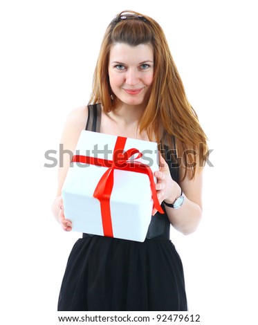 The beautiful girl smiling holds a gift in a box on a white background