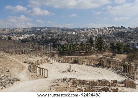 View down onto the Oval Plaza in the ancient Roman city of Jerash, Jordan. You can see the modern city of Jerash in the background.
