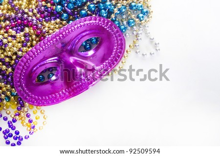 Mardi gras mask and colorful beads