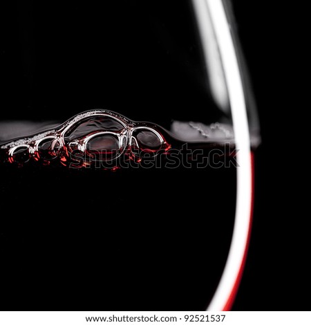 Red Wine Glass silhouette on Black Background with Bubbles