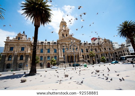 pigeons flying over city hall of cape town, south africa Royalty-Free Stock Photo #92558881