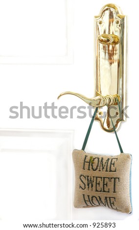 Brass door handle with cross stitched pillow