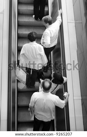 People ascending escalators and stairs