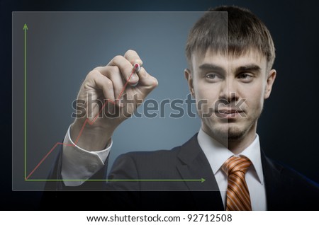 portrait  the  beautiful  businessman careerist in black costume, hold marker in hand and write on camera and write diagram