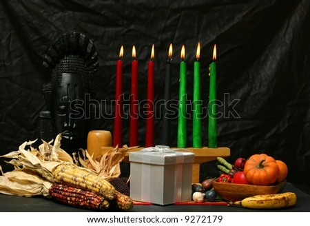 Kwanzaa display with candles lit and a gift
