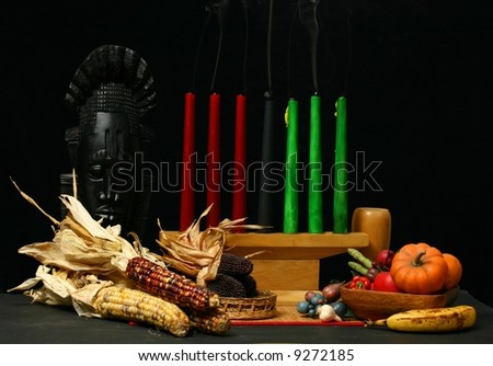 Kwanzaa display with candles out and smoke rising indicating an end of Kwanzaa