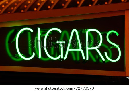 Neon cigar sign on a storefront