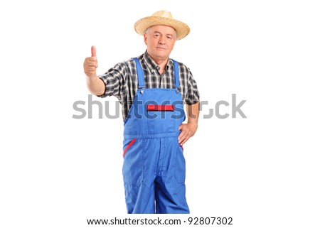 Mature smiling farmer giving a thumb up isolated on white background