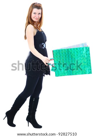 Side view of young female with shopping against a white background