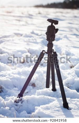 Outdoor photography in winter: tripod sitting in snow
