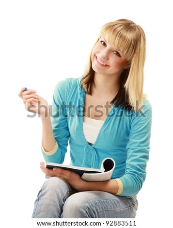A pensive college girl with a pen and a textbook, isolated on white background