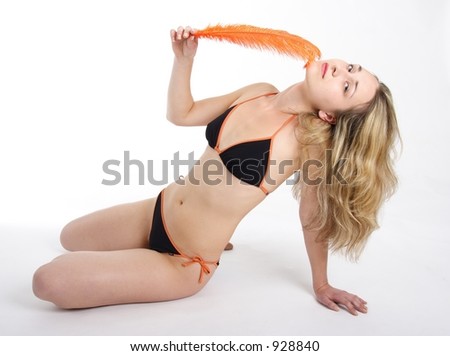 Beautiful blond woman holding an orange feather