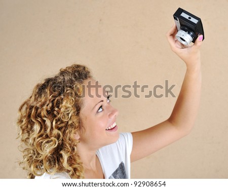 Excited girl with holding camera