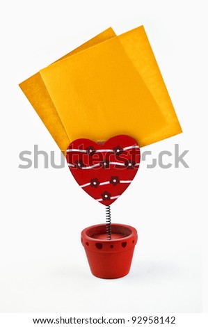 Heart-shaped holder holding two blank sticky notes