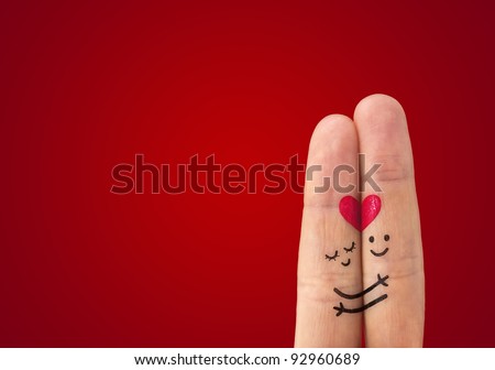 A happy couple in love with painted smiley and hugging Royalty-Free Stock Photo #92960689