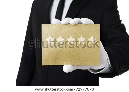 Five stars service, well dressed man holding gold card with 5 stars on it Royalty-Free Stock Photo #92977078