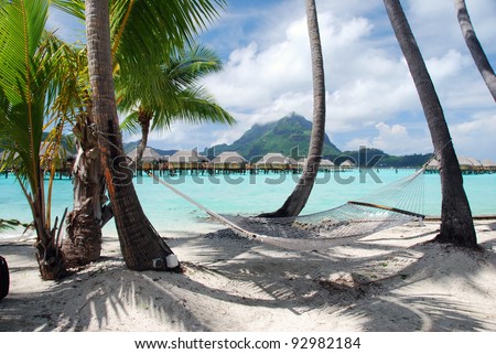 View of the Otemanu mountain ,  the palms with hammock and the lagoon , Bora Bora , French Polynesia , South Pacific ocean Royalty-Free Stock Photo #92982184