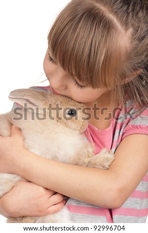Easter concept image. Portrait of happy little girl with adorable rabbit over white background.