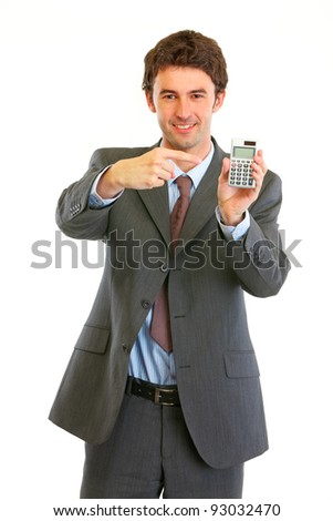 Smiling modern businessman pointing finger on calculator