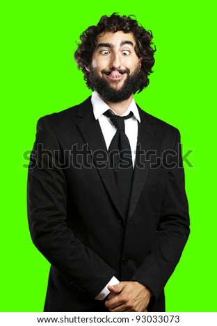 portrait of young business man showing the tongue against a removable chroma key background
