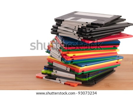 Stack of Used Floppy Diskettes Sitting on Wood Surface with Room for Text