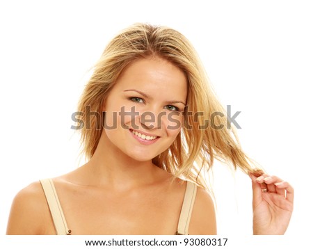 Closeup of positive young woman touching her hair isolated on white background