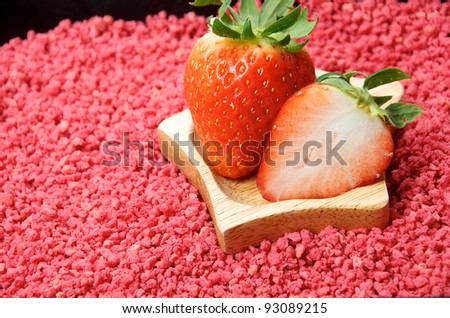 fresh strawberries with star shaped dish on red background