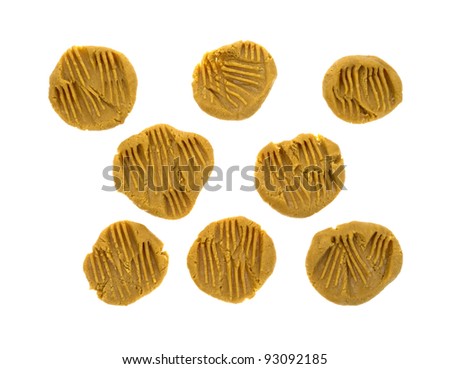 Several ready to be cooked peanut butter cookies on a white background.