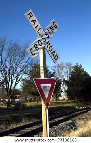 Railroad and warning yield sign at railroad crossing
