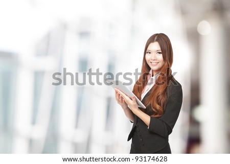 Business woman smile using tablet pc, model is a asian beauty