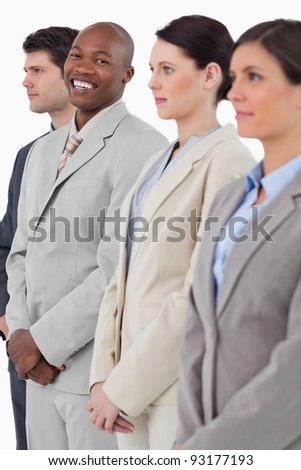 Smiling businessman standing between his associates against a white background
