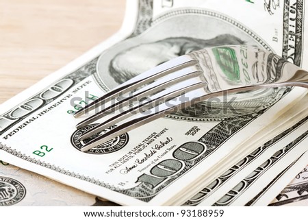 Fork and dollars on the wood table